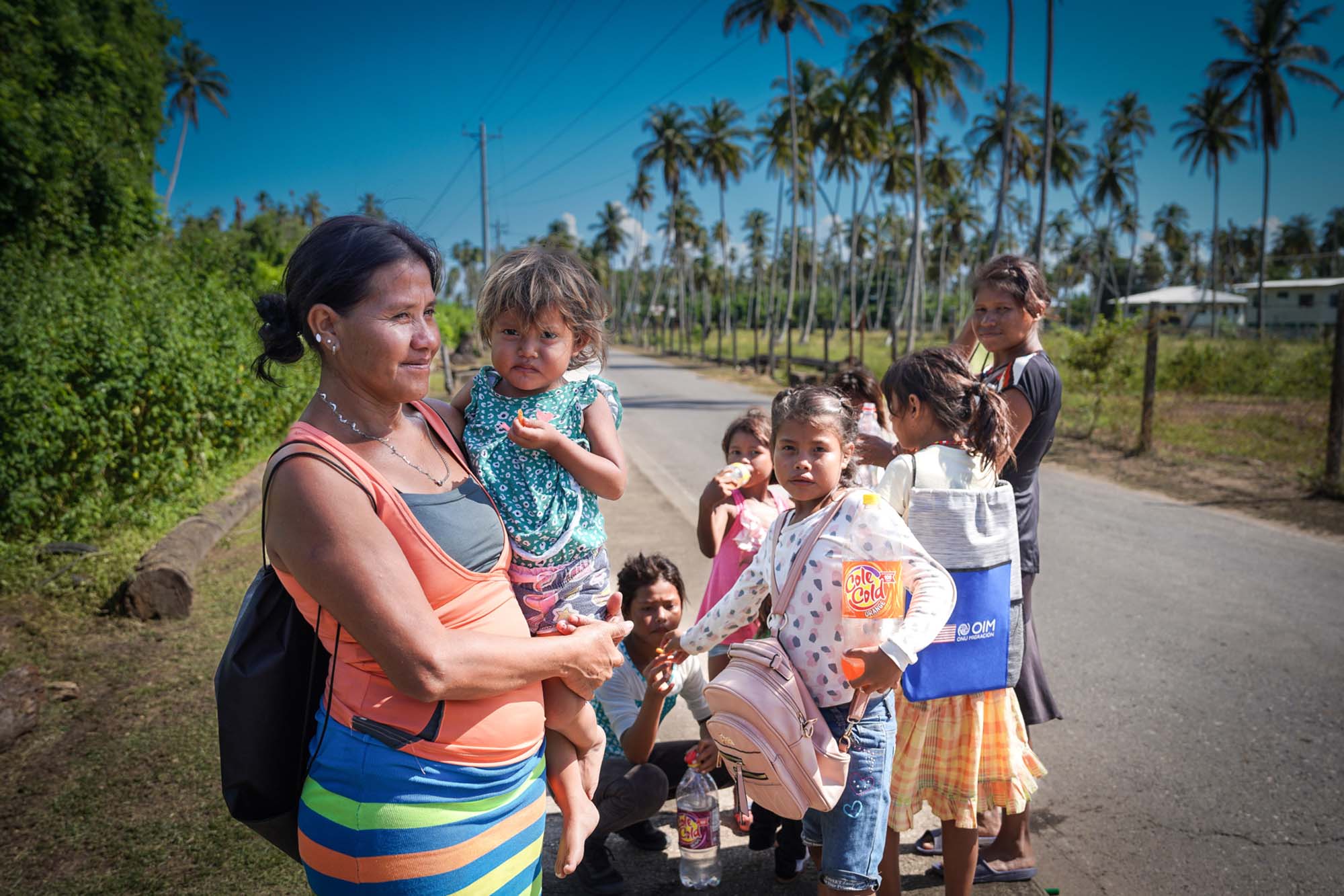 : A family walking to a local church for cash distribution in Trinidad and Tobago.