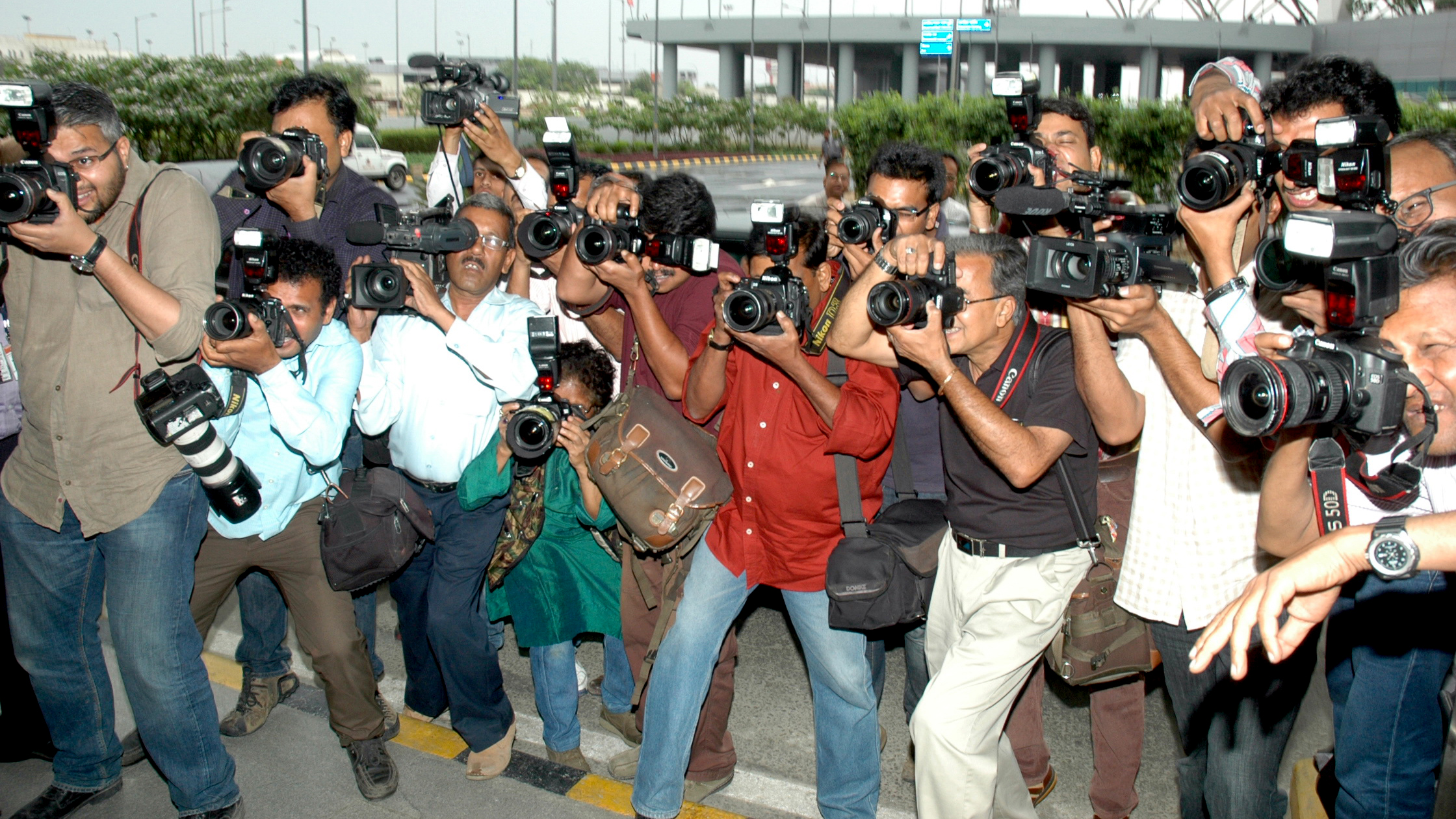 Photo: UNIC New Delhi A group of people pointing professional cameras at the camera